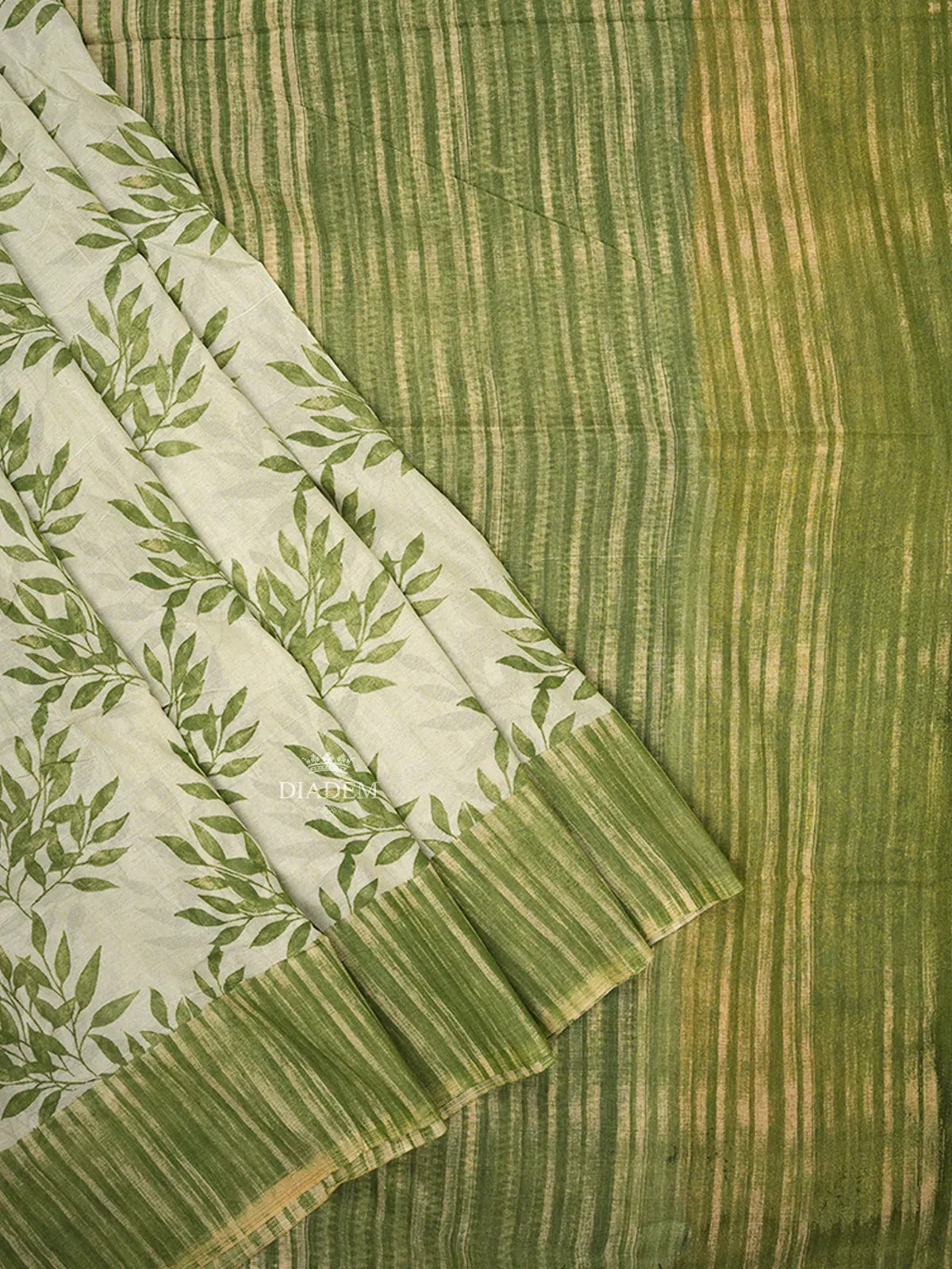 Cream Cotton Saree with Leaf Designs on the Body with Contrast Green Border